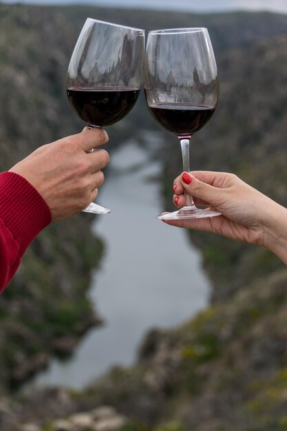 close-up-hands-toasting-mountains_1048944-10040585